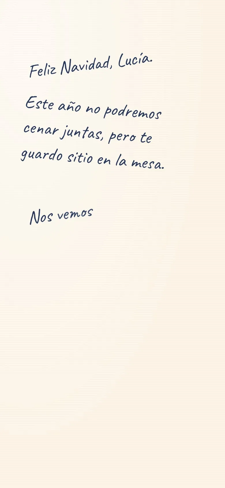 Mensaje de Navidad escribiéndose a mano dentro de la tarjeta abierta